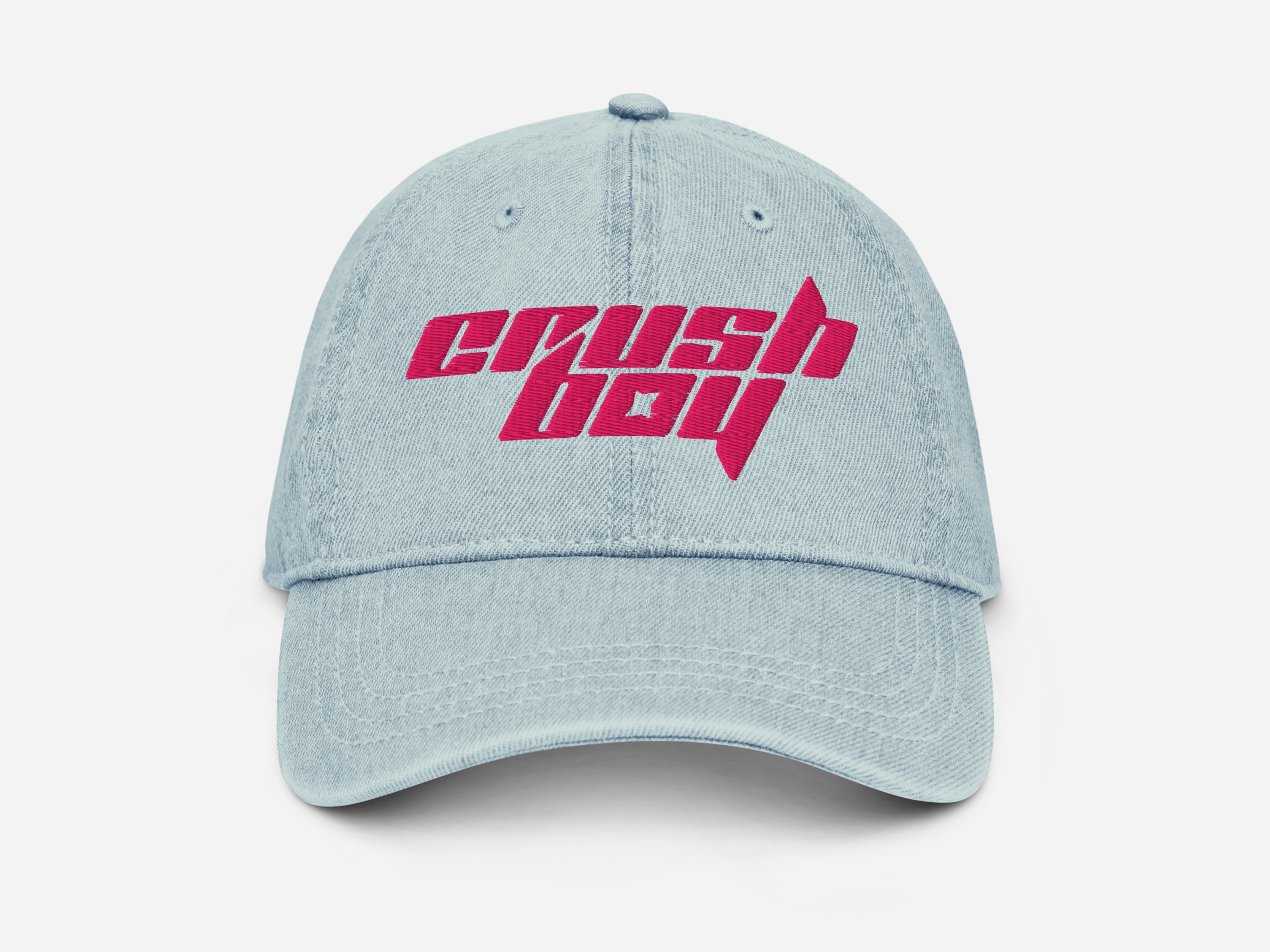 A light blue denim baseball cap featuring a bold pink embroidered 'CRUSHBOY' logo on the front, set against a clean white background.