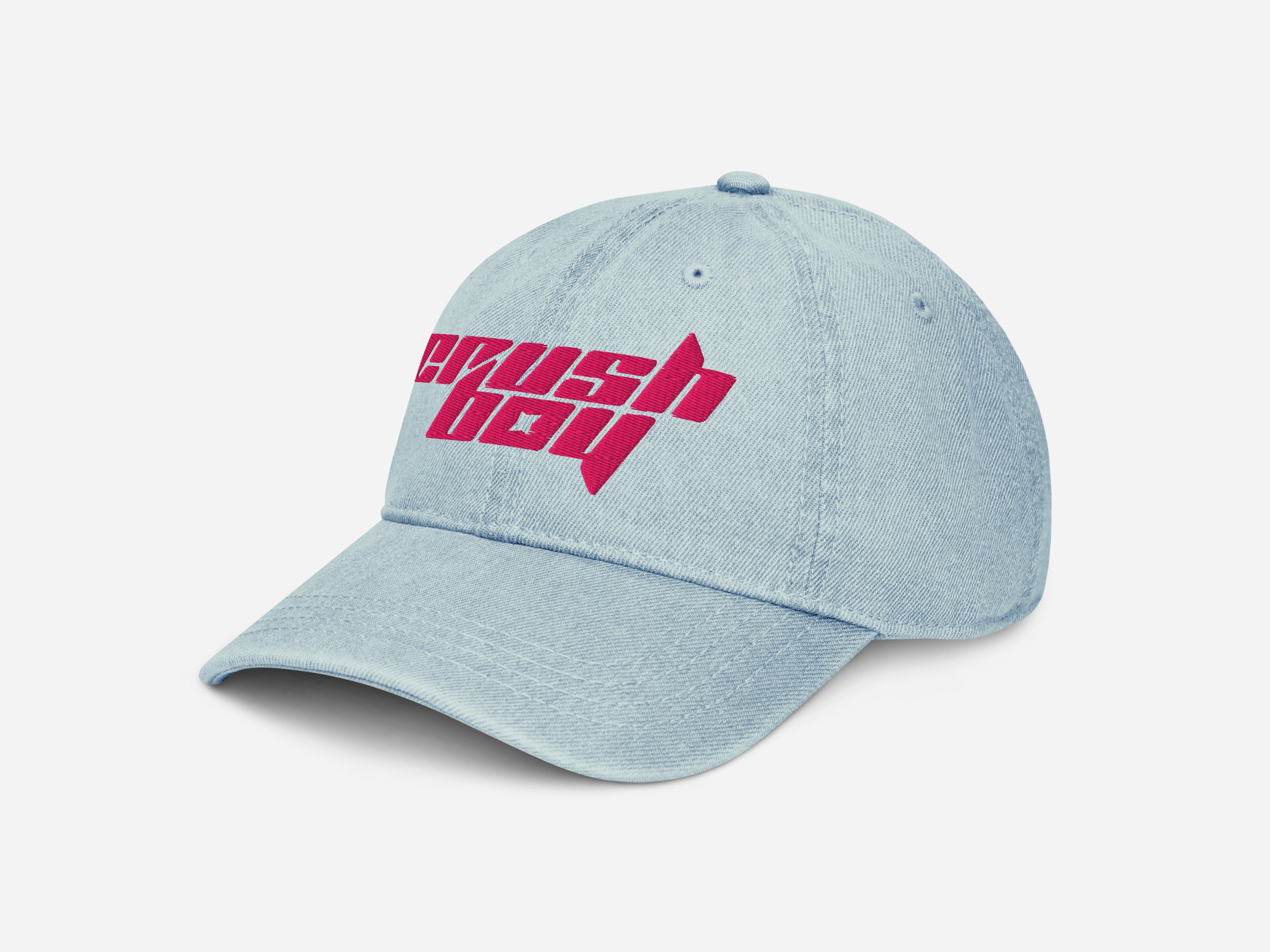 A light blue denim baseball cap featuring a bold pink embroidered 'CRUSHBOY' logo on the front, set against a clean white background.