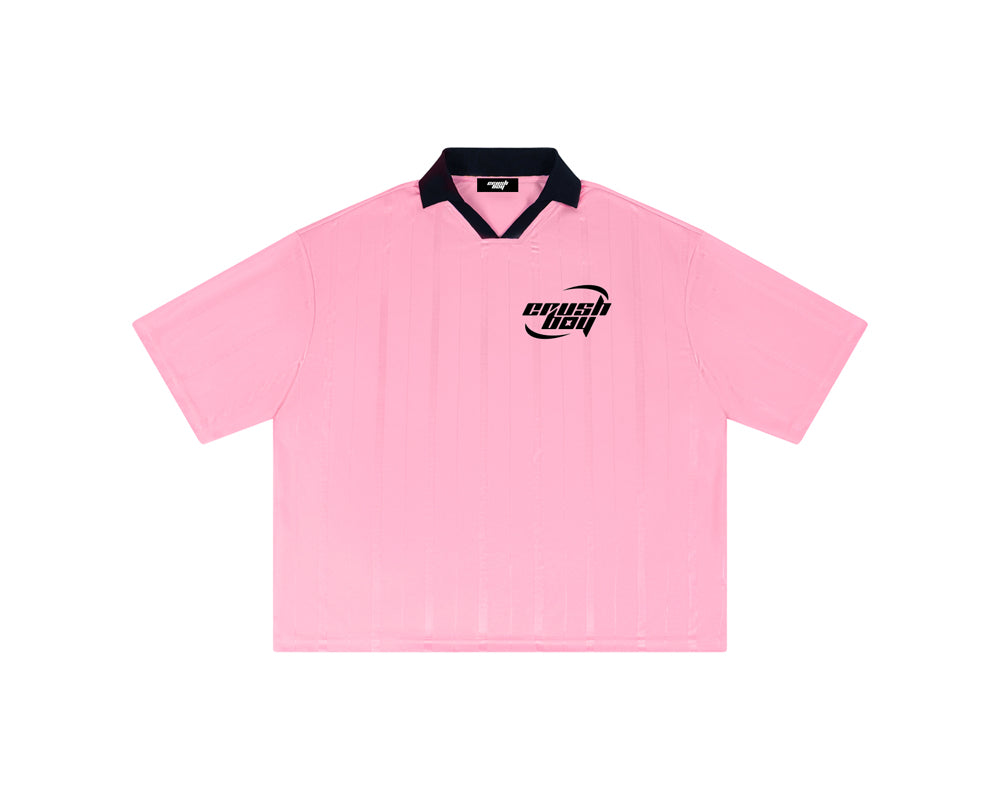 A light pink short-sleeve polo shirt with a black collar and a black 'crushboy' logo on the left chest, displayed flat against a solid white background.